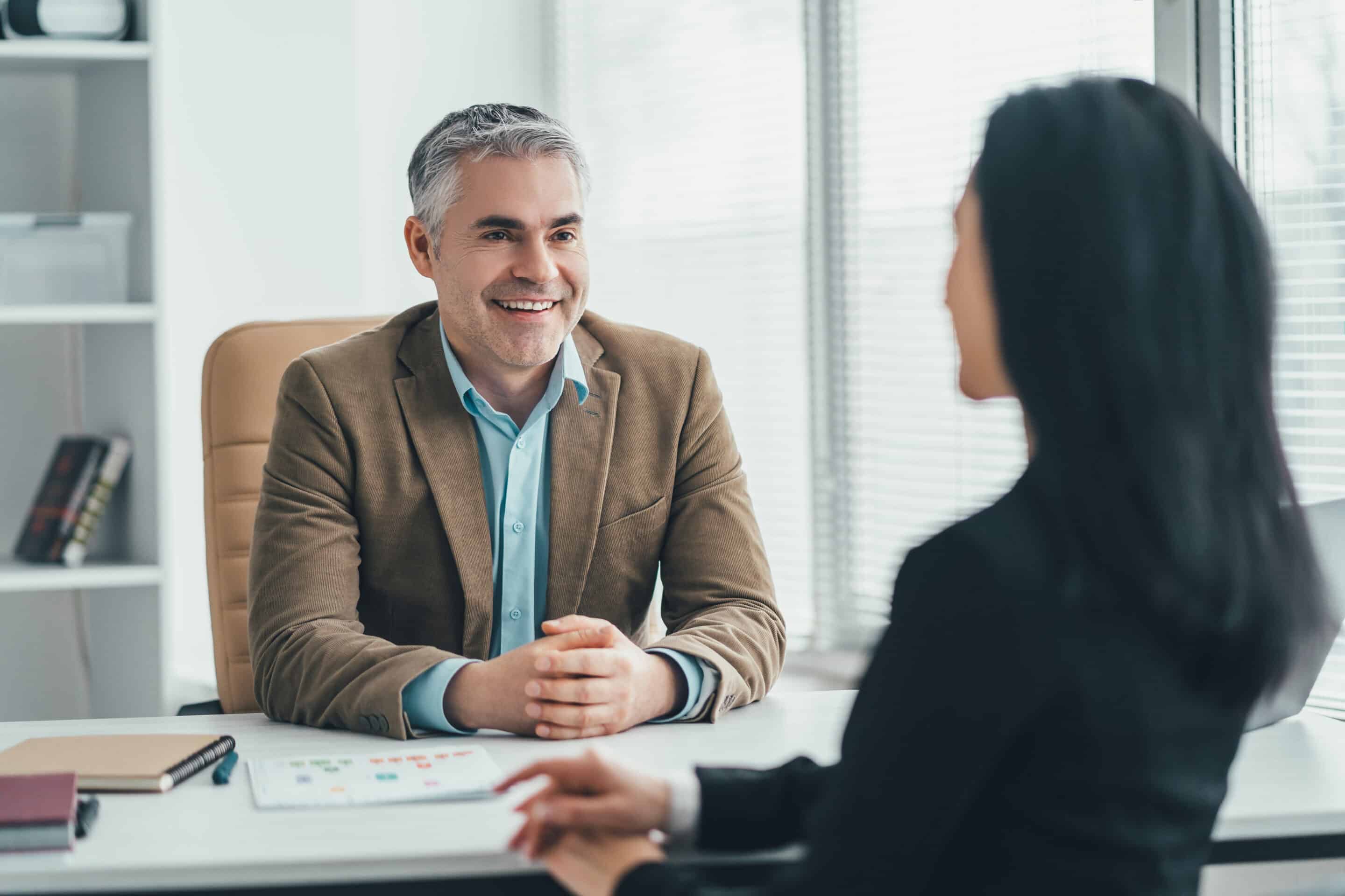 The two business people talking at the office table The two business people talking at the office table